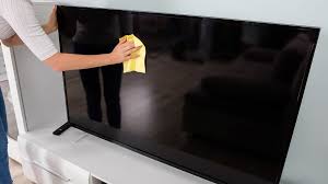 shows cleaning a TV screen with dry cloth