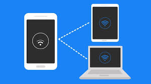Shows a laptop and a tablet connected to hotspot from a mobile device